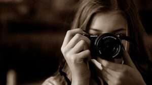 female-private-investigator-holding-camera-to-click-a-image-