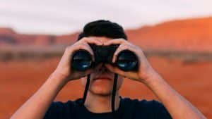 private-detective-holding-binoculars-for-surveillance