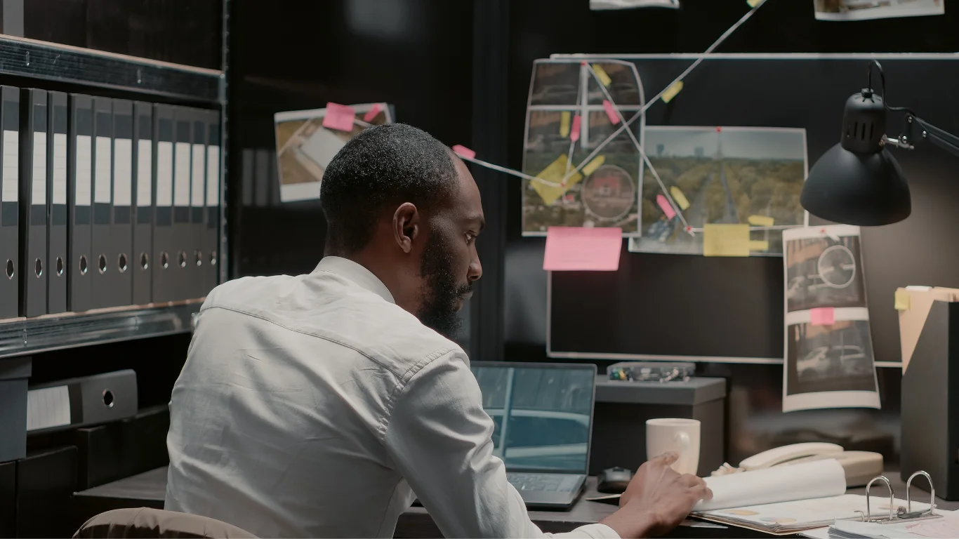a-private-investigator-working-in-his-office